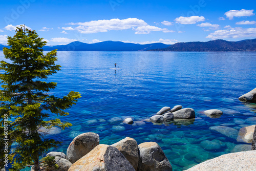 Person on Stand-up Paddleboard in Lake Tahoe near Sand Harbor, North Lake Tahoe Nevada facing towards the California side of Lake Tahoe