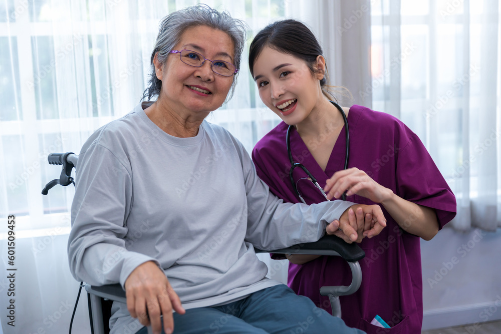 Obraz premium Caregiver nurse take care a Senior patient walking in park. Nurse helping senior Woman