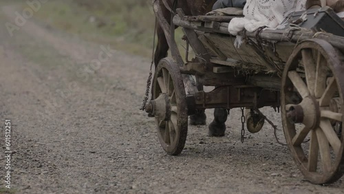 Old wooden cart wheel at sand beach. Cinematic shot for film