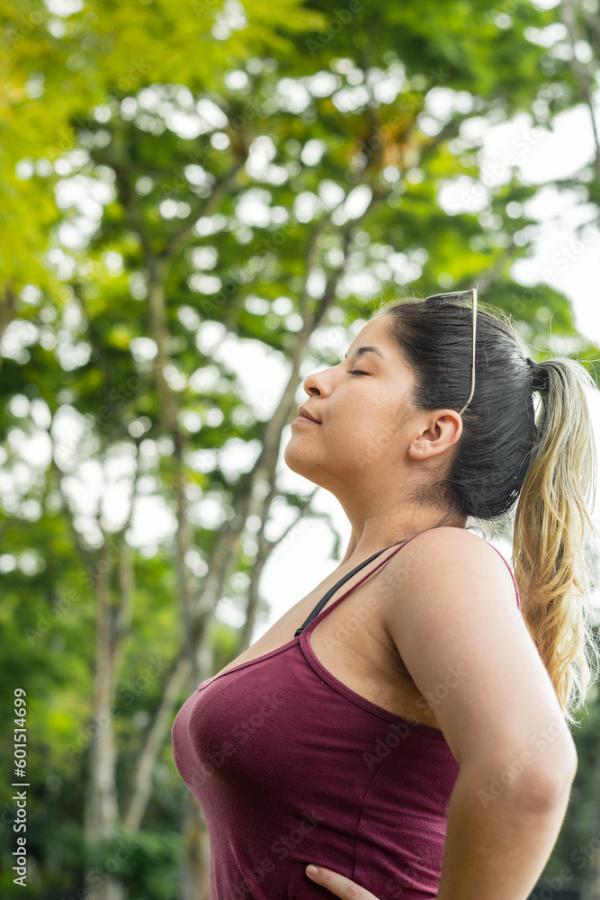 vertical close-up of a beautiful latin girl, ecologist nourishing her lungs with fresh air vertical close-up of a beautiful latin girl, ecologist nourishing her lungs with fresh air
