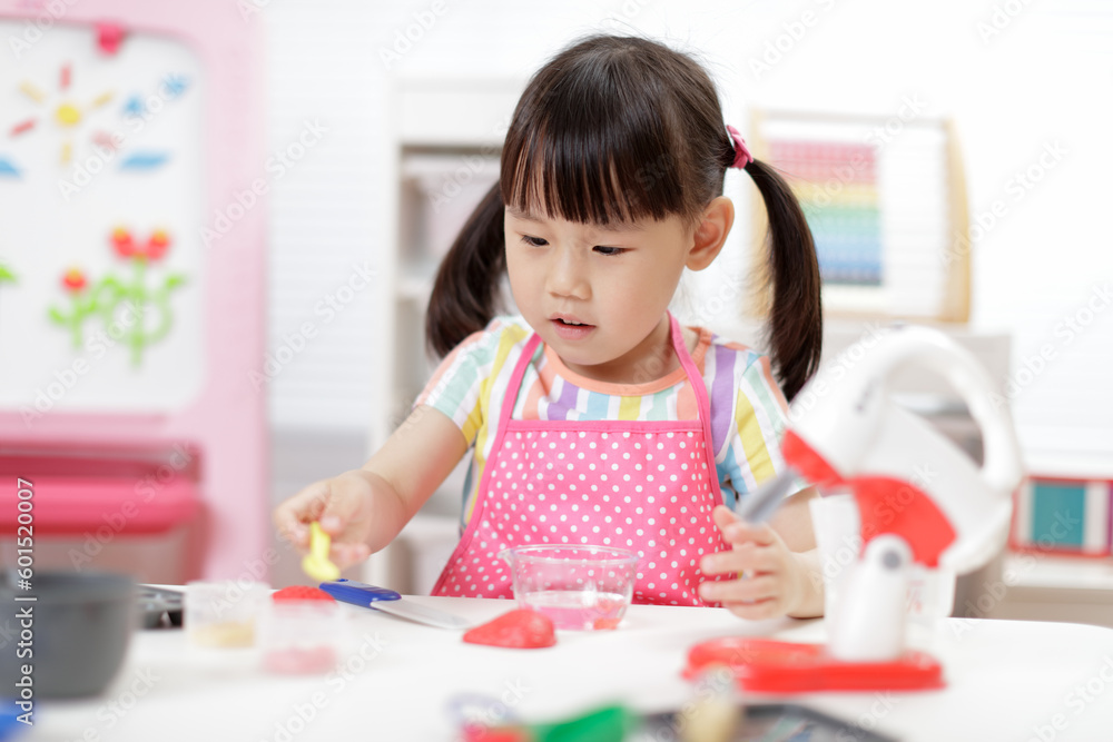 young girl pretend play food preparing at home young girl pretend play food preparing at home