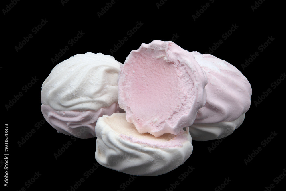 White and pink marshmallows on a black background. White and pink marshmallows on a black background.