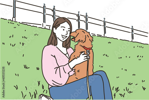屋外で犬触れ合う若い女性
