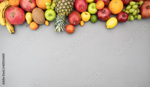 Fresh juicy fruits on gray