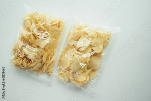 top view of potato chips in a plastic packet on white 