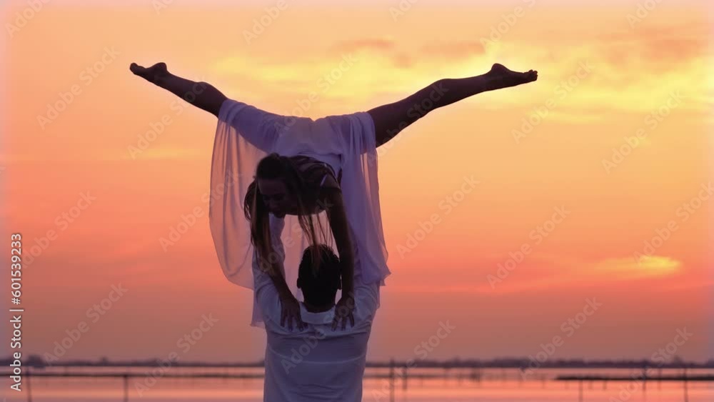 Woman and man perform difficult ballet support on bridge Woman and man perform difficult ballet support on bridge
