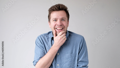 European funny young man is laughing loudly. Positive emotion photo