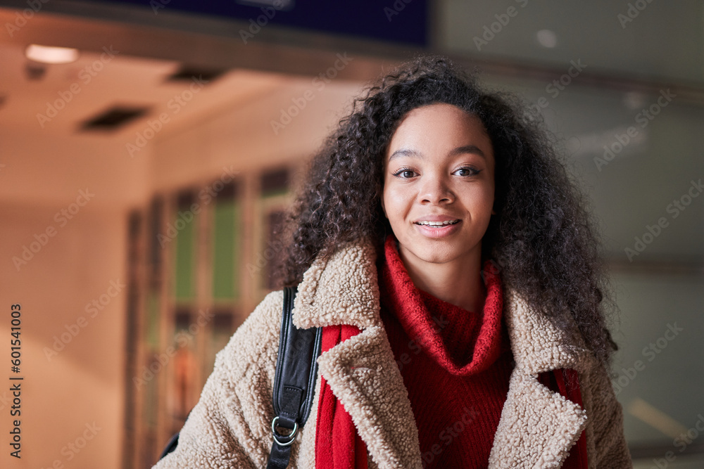 Portrait of the cute curly girl looking at the camera and smiling Portrait of the cute curly girl looking at the camera and smiling