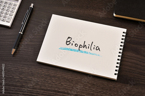 There is notebook with the word Biophilia.It is as an eye-catching image.
