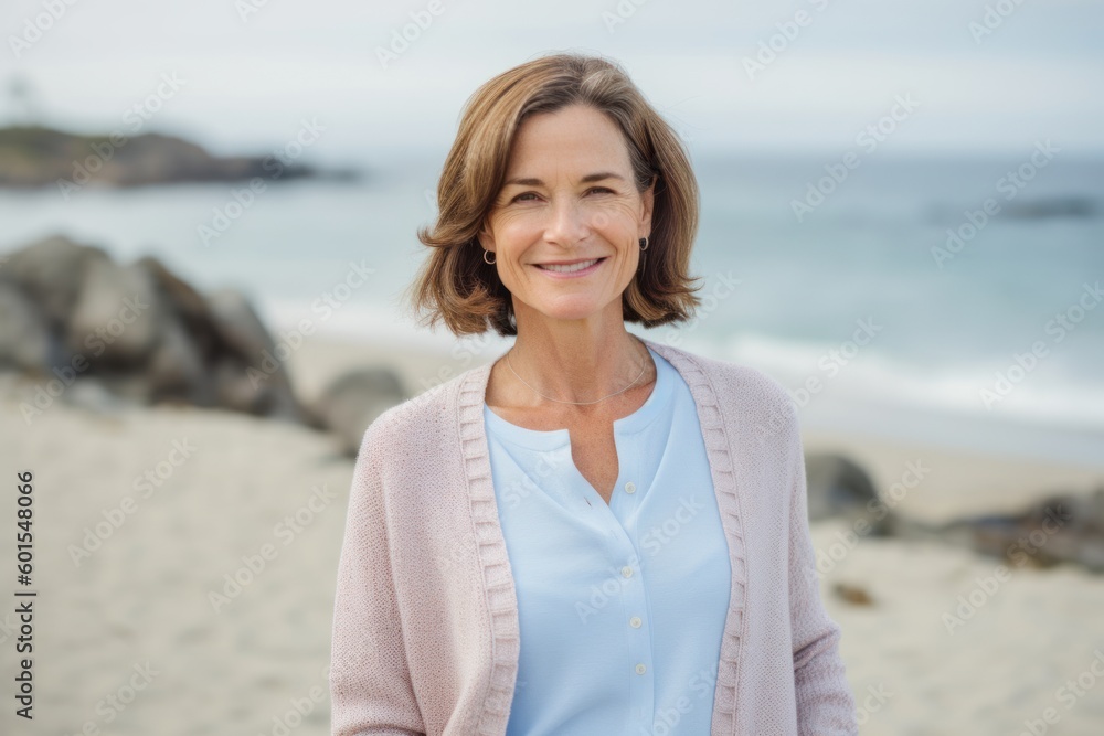 Portrait of smiling senior woman standing on the beach at the day time Portrait of smiling senior woman standing on the beach at the day time