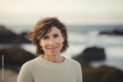 Portrait of smiling mature woman standing on beach at the day time © Hanne Bauer