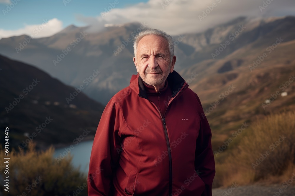 Environmental portrait photography of a satisfied man in his 70s wearing a comfortable tracksuit against a mountain landscape background. Generative AI