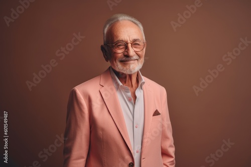 Portrait of an old man in a pink suit on a brown background.