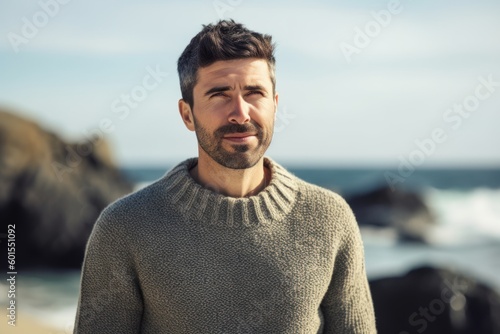 Portrait of handsome man standing on the beach at the day time