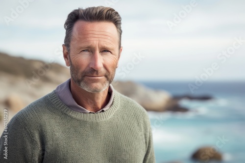 Portrait of smiling mature man at the beach on a sunny day