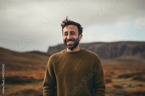 Portrait of a handsome young man with beard in the mountains.
