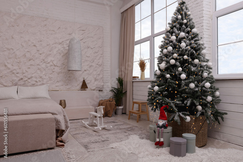 Bedroom interior with Christmas tree and festive decor © New Africa