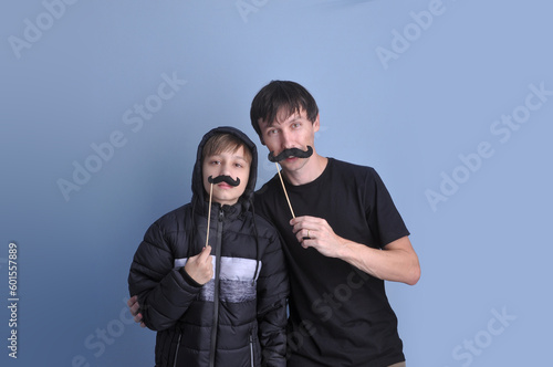 pai e filho brincando com bigodes, diverção no dia dos pais  photo