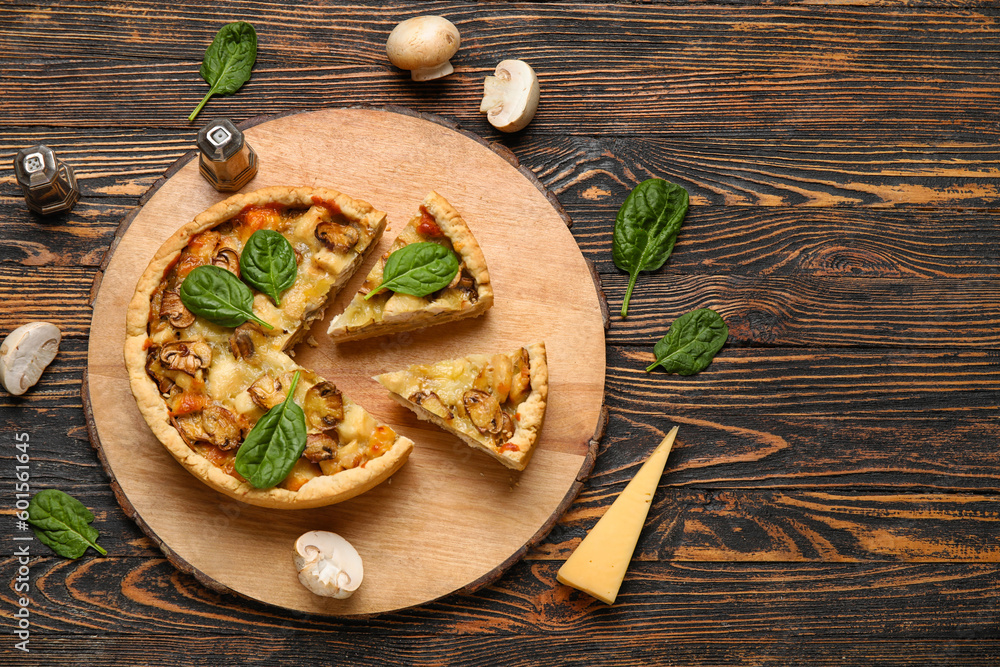 Pieces of mushroom pie with spinach leaves and champignons on brown wooden table Pieces of mushroom pie with spinach leaves and champignons on brown wooden table
