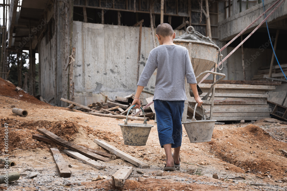  Poor little boy working at construction site, human trafficking, poor child labor. World day against child labour concept. - obrazy, fototapety, plakaty 