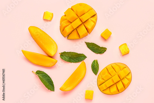 Fresh cut mangoes on light pink background