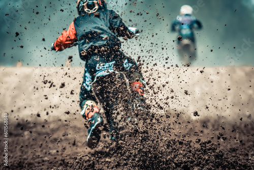 Details of mud and debris in a motocross race, Motocross rider accelerating on dirty track with mud and debris.