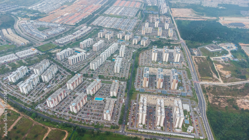 Aerial view of residential area with green asphalt road and residential houses directly above viewpoint. View of suburbs and city district. Real estate and housing market concept.
