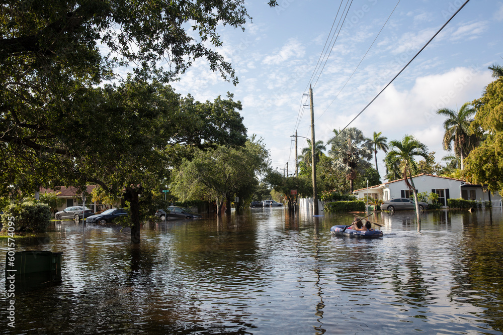 FLOODED STREETS IN SOUTH FLORIDACOUPLE IN AN INFLATABLE RAFT NAVIGATES FLOODED STREETS FLOODED STREETS IN SOUTH FLORIDACOUPLE IN AN INFLATABLE RAFT NAVIGATES FLOODED STREETS