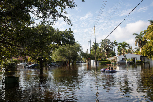 FLOODED STREETS IN SOUTH FLORIDACOUPLE IN AN INFLATABLE RAFT NAVIGATES FLOODED STREETS
