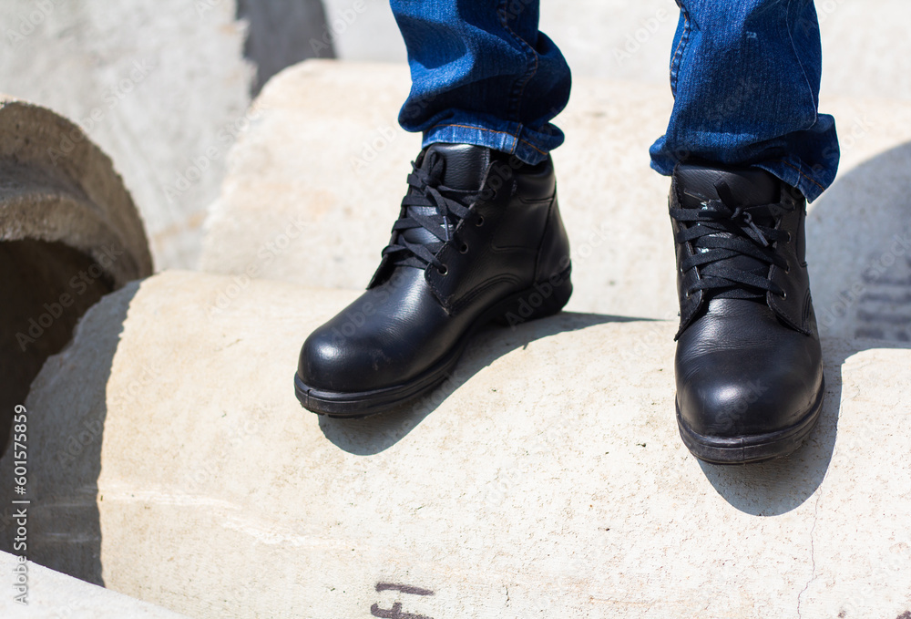 Wear safety shoes to ensure safety at work. construction workers wear safety shoes. People with