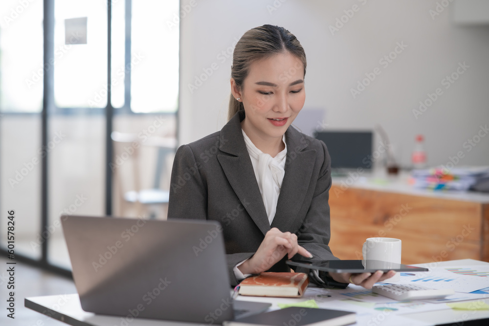 Young Asian businesswoman working on documents at office Young Asian businesswoman working on documents at office