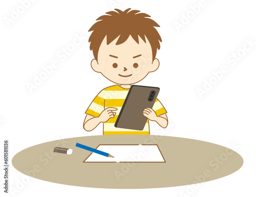 タブレットで調べながら勉強する男の子