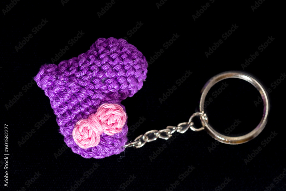 crocheted purple heart-shaped keyrings on a black background