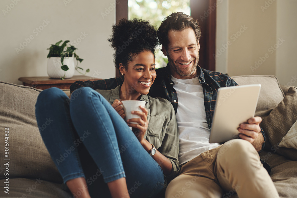 Relax, home and interracial couple on a couch, tablet and happiness with social media and connection. Partners, man and woman on a sofa, technology and loving with a smile, romance and online reading - obrazy, fototapety, plakaty 