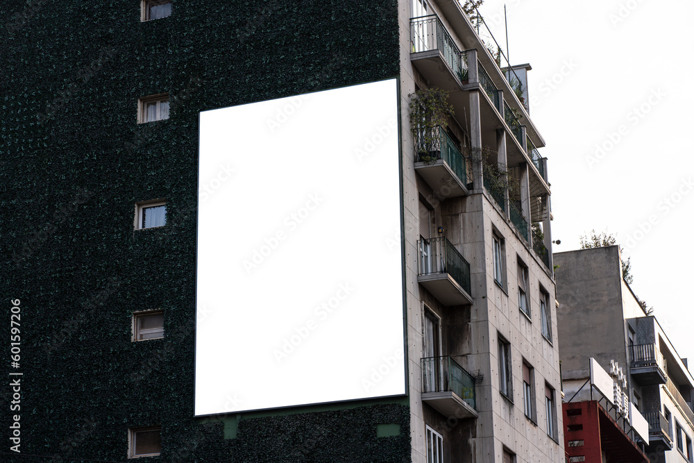 Fototapeta premium Large screen advertisement in Milan on a residential building wall.
