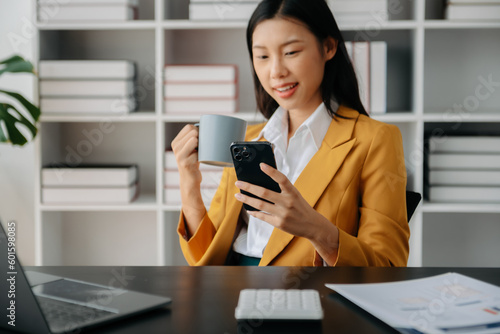 Businesswoman hand using laptop, tablet and smartphone in office. Digital marketing media mobile app and discussing plan new start up project. Finance task..