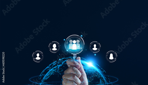 Fototapeta Naklejka Na Ścianę i Meble -  Businessman use magnifying glass to find human icon for business CRM or Customer Relation Management and customer focus target group concept, social media. Digital marketing online. HRM, human manage.