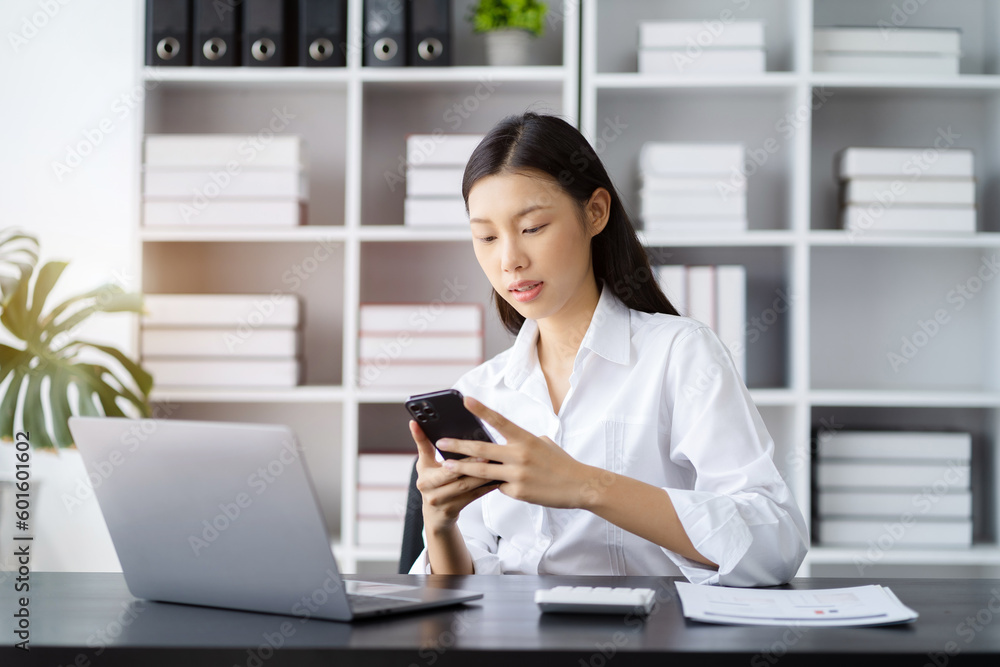 Businesswoman using mobile phone play social in home office. Businesswoman using mobile phone play social in home office.