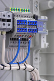 Electrical terminals with connected mounting wires are installed in an electrical switchboard for connecting electrical loads.