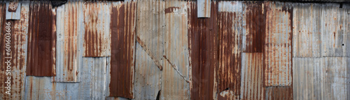 Background made of rusted iron sheet metal and corrugated iron which are fastened together. Widescreen image