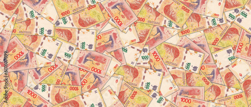 Seamless pattern. Financial illustration. Banknotes of 1000 Argentine pesos. Randomly scattered bills.