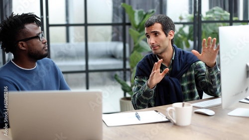 Business people working together in a modern trendy office behind a laptop. The concept of joint discussion of the project