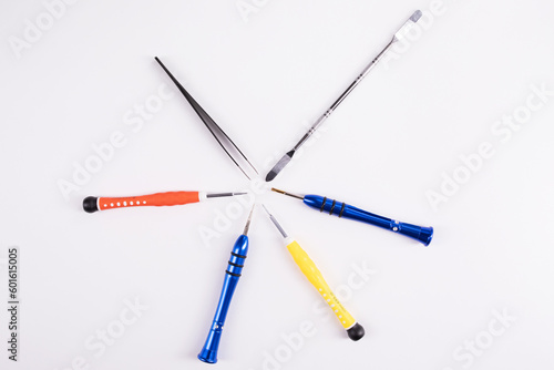 Top view of phone repair tools on a white background