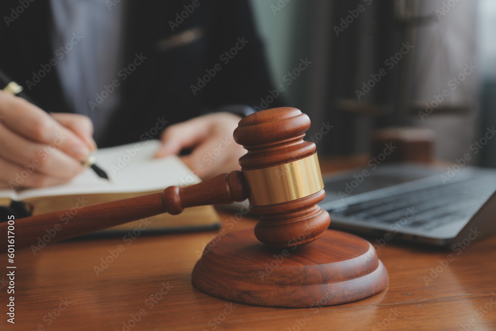 Business and lawyers discussing contract papers with brass scale on desk in office. Law, legal services, advice, justice and law concept picture with film grain effect Business and lawyers discussing contract papers with brass scale on desk in office. Law, legal services, advice, justice and law concept picture with film grain effect