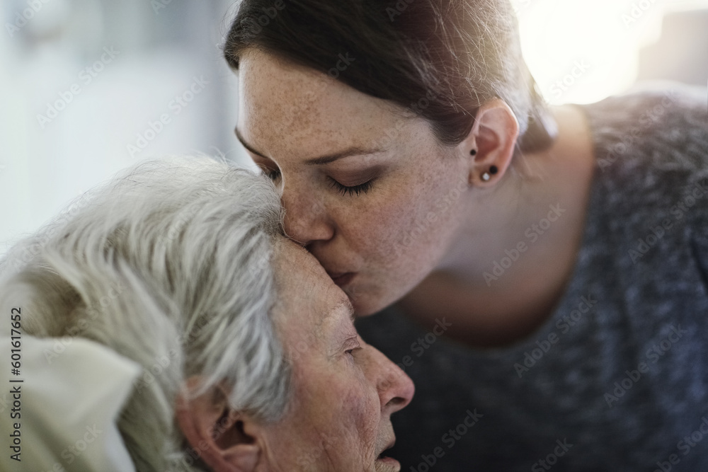 Obraz premium Senior, daughter and kiss mother in hospital for healthcare, visiting sick patient and resting. Clinic, woman and kissing elderly mom on forehead with love, care and empathy, kindness and comforting.