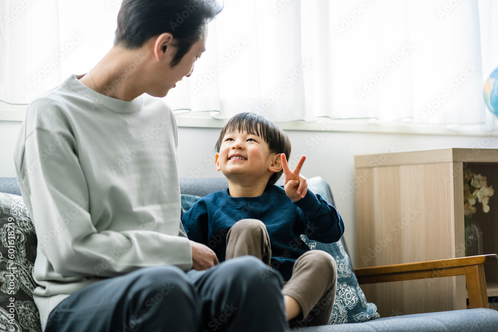 ソファーに座る日本人の父親と息子 ソファーに座る日本人の父親と息子