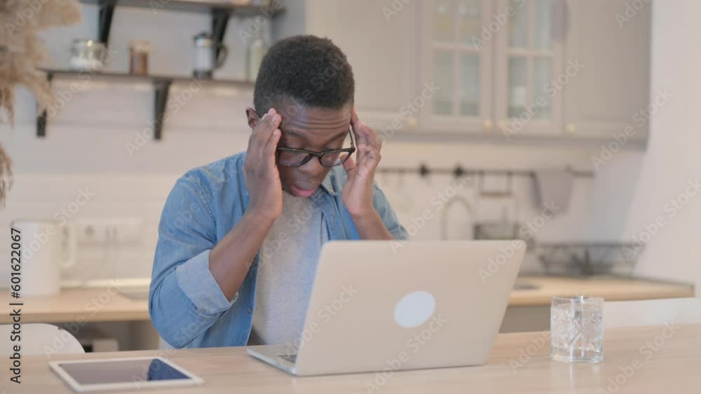 Young African Man with Headache Working on Laptop Young African Man with Headache Working on Laptop