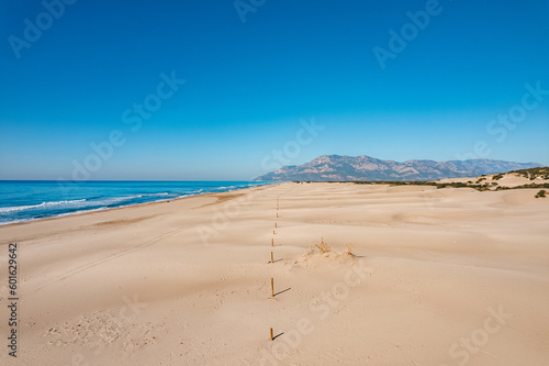 Fototapeta Naklejka Na Ścianę i Meble -  Beautiful Patara sandy beach with blue sea Kalkan, Antalya Turkey. Aerial top view from drone