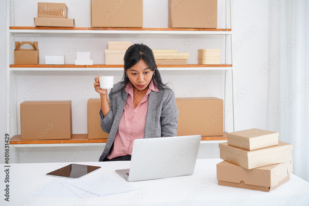 Photo of success young woman sitting on desk at office, holding a cup Photo of success young woman sitting on desk at office, holding a cup