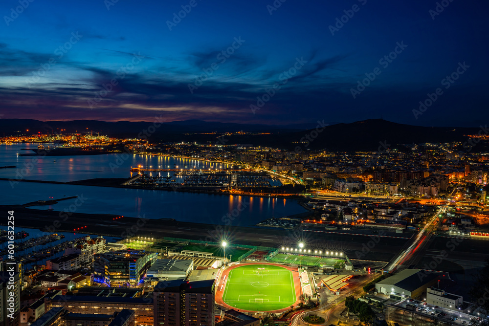Sunset over Gibraltar town and  and Spanish town of La Linea de la Concepcion across the Bay of Gibraltar, UK
